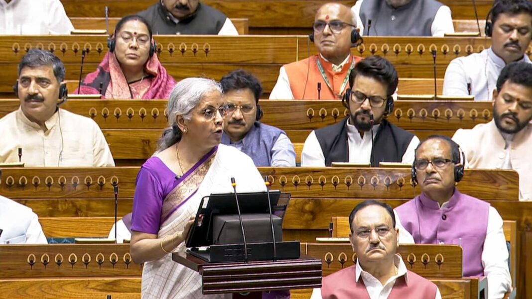 Woman speaking at legislative assembly podium.