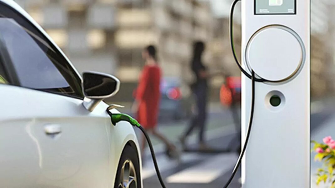 Electric car charging at street station.