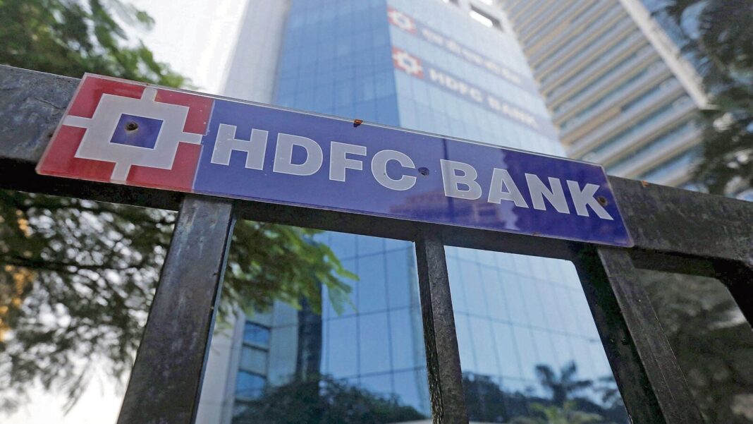 HDFC Bank signboard with reflective building background.