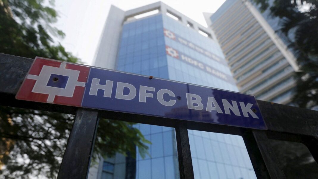 HDFC Bank sign with skyscraper in background.