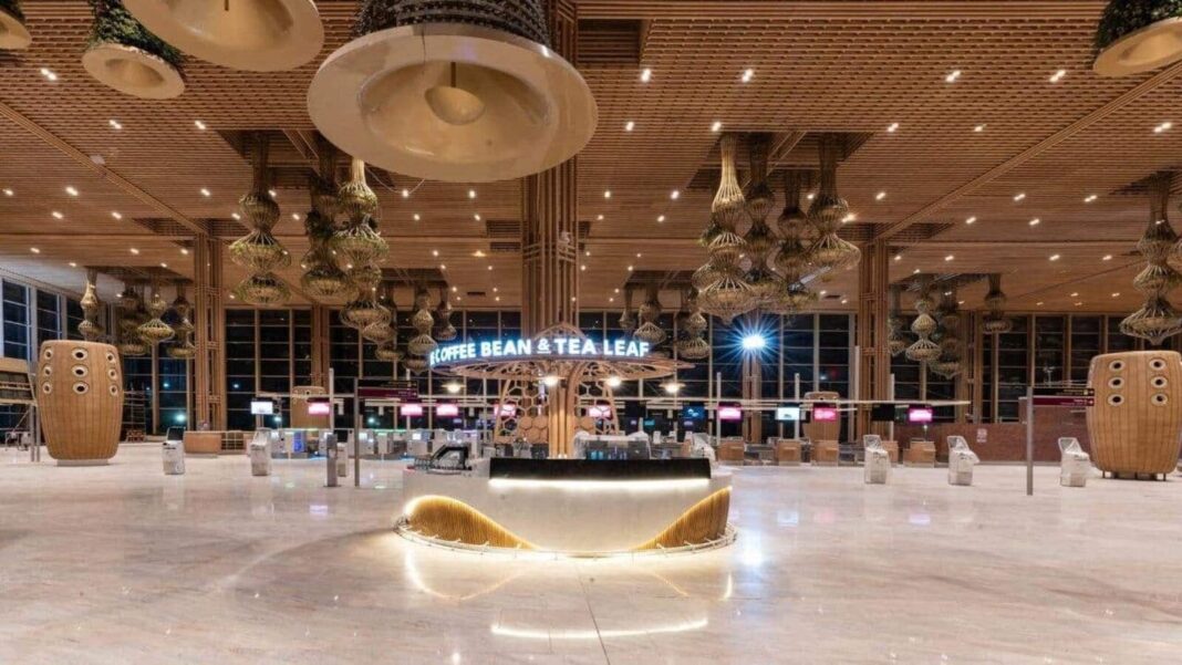 Modern airport interior with coffee shop at night.