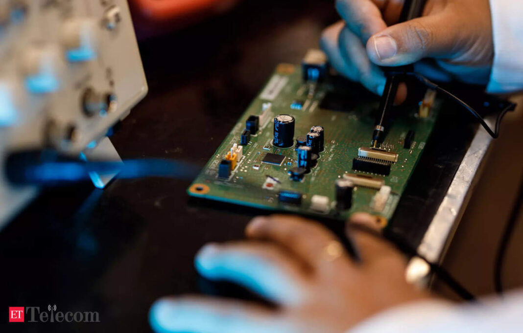 Technician soldering components on a circuit board.