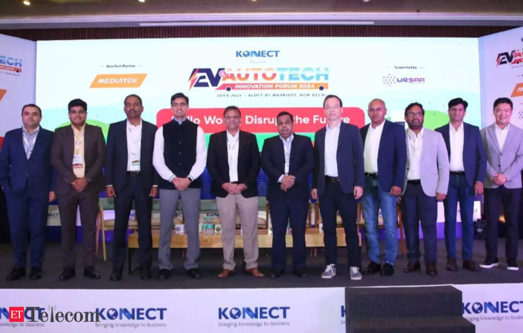 Professionals posing at AutoTech Innovation Forum event.