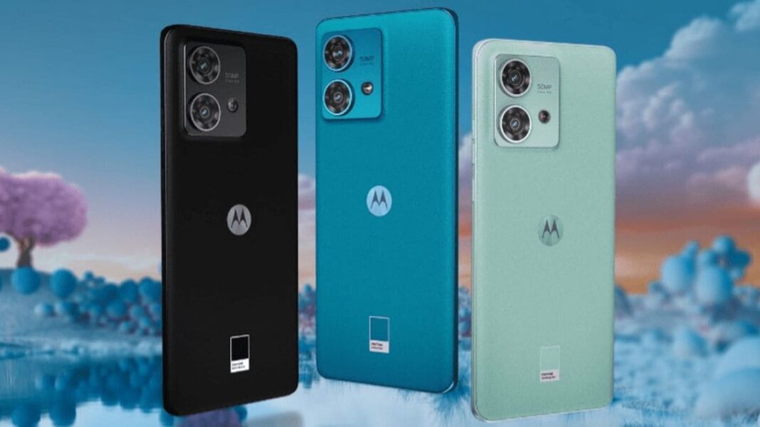 Three Motorola smartphones with cameras on abstract background.