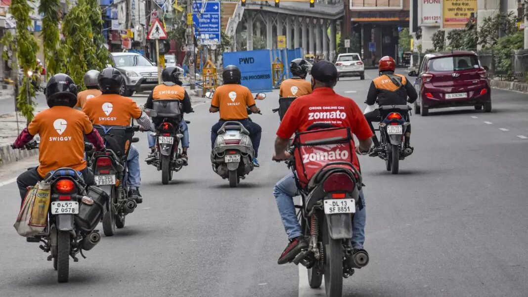 Delivery riders on city street in branded uniforms.