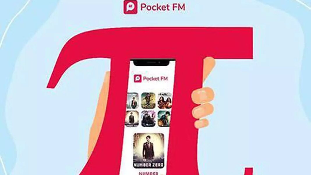 Hand holding smartphone with Pocket FM app displayed.