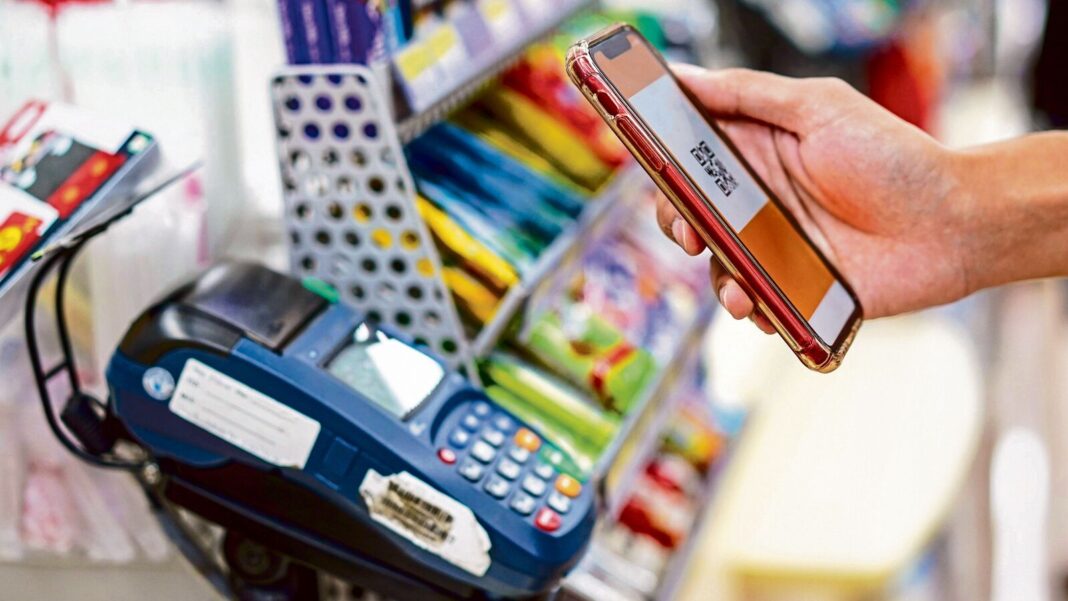 Mobile payment at a grocery store checkout.