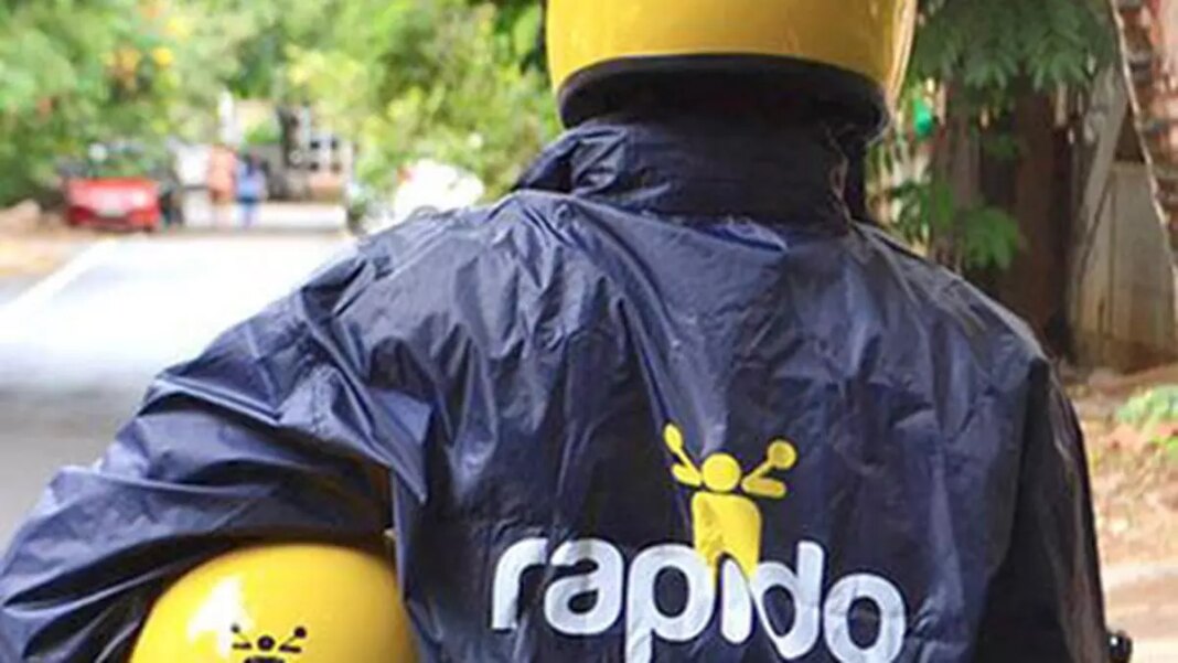 Delivery person with yellow helmet and branded raincoat.