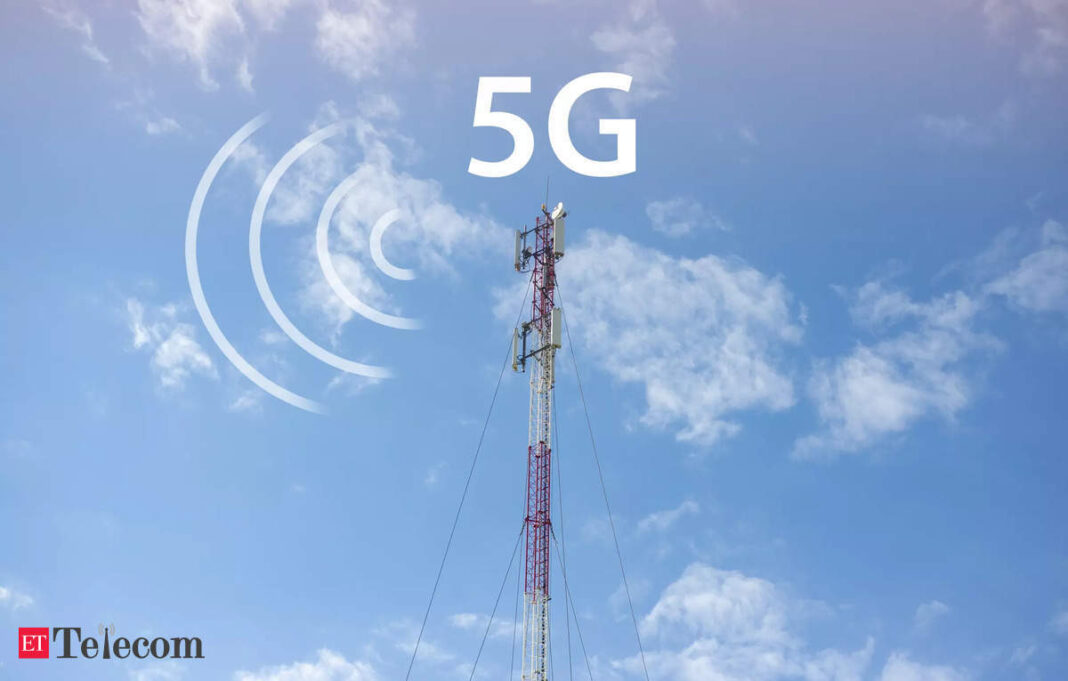 5G network cell tower against cloudy sky.