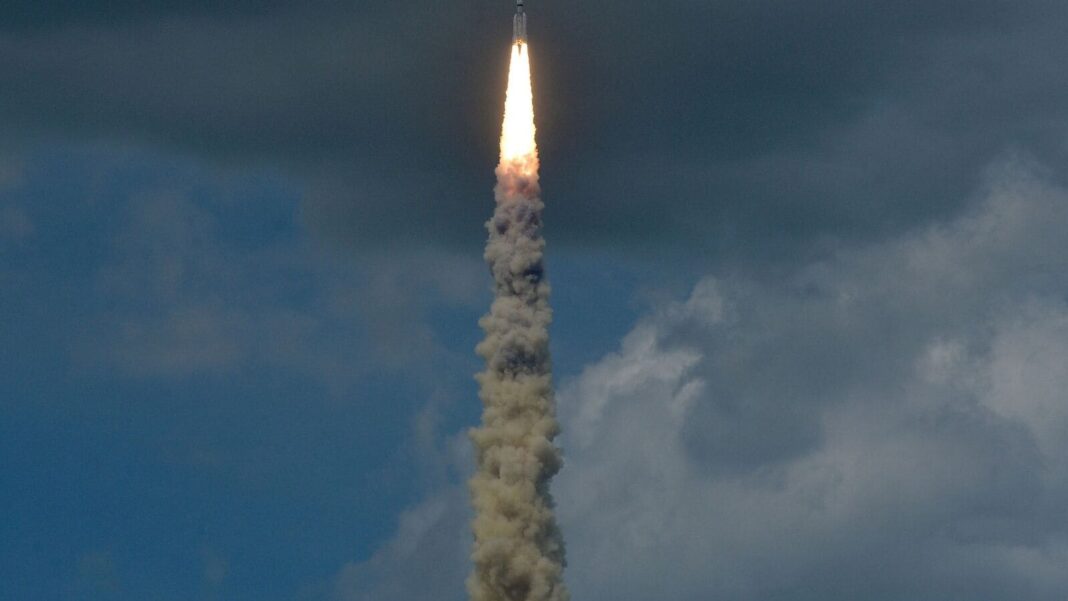 Rocket launch with fiery exhaust and smoke trail.