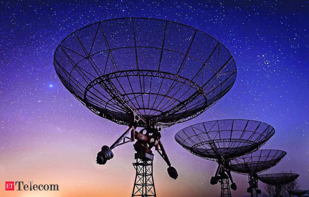 Radio telescopes against starry night sky.