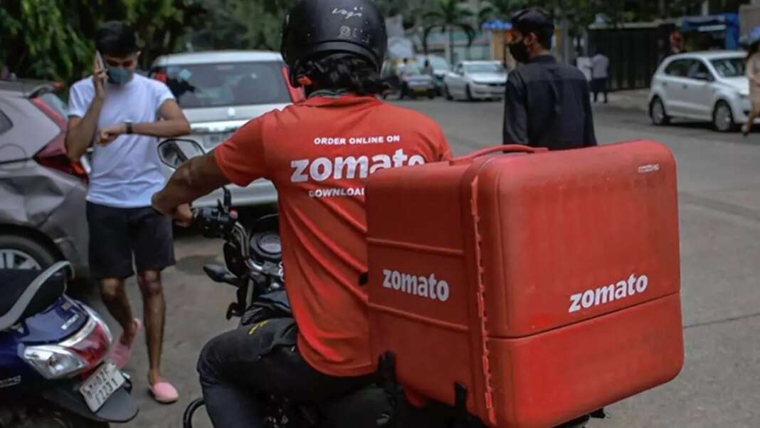 Zomato delivery rider with food backpack on motorcycle.