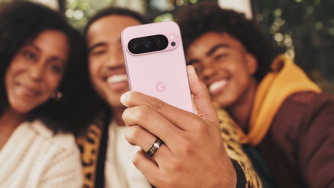 Friends taking selfie with pink smartphone.