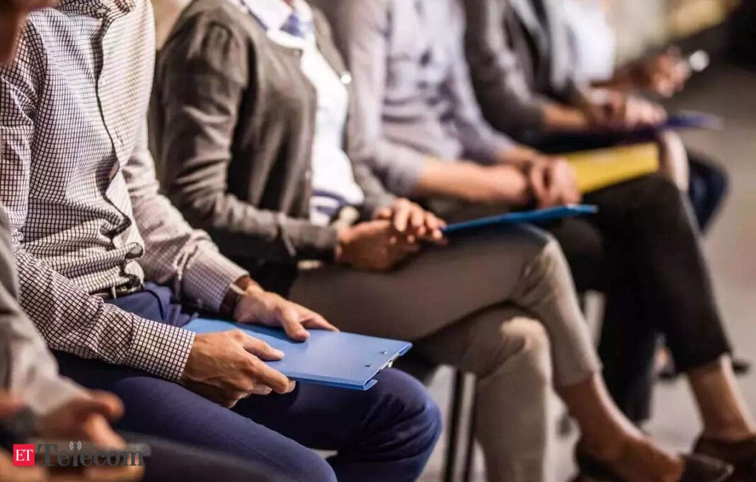 Professionals seated with notepads during a seminar.