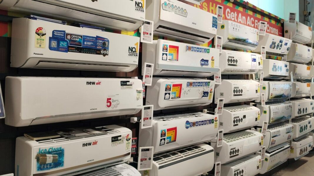 Assorted air conditioners on display in store.