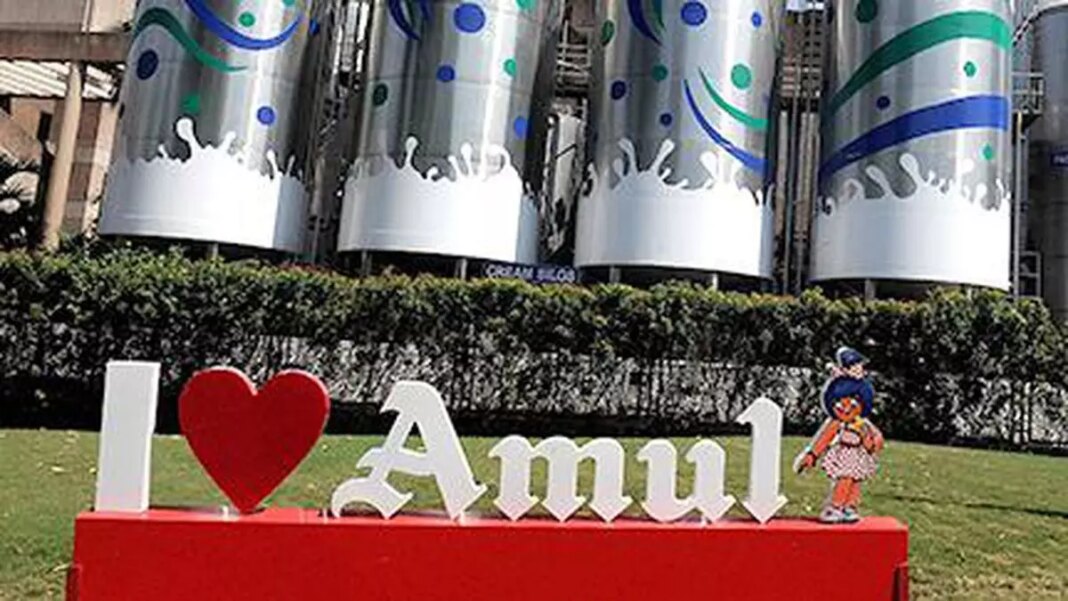 I Love Amul" sign with mascot outdoors.