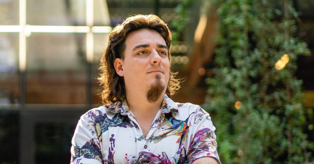 Man in colorful shirt smiling outdoors