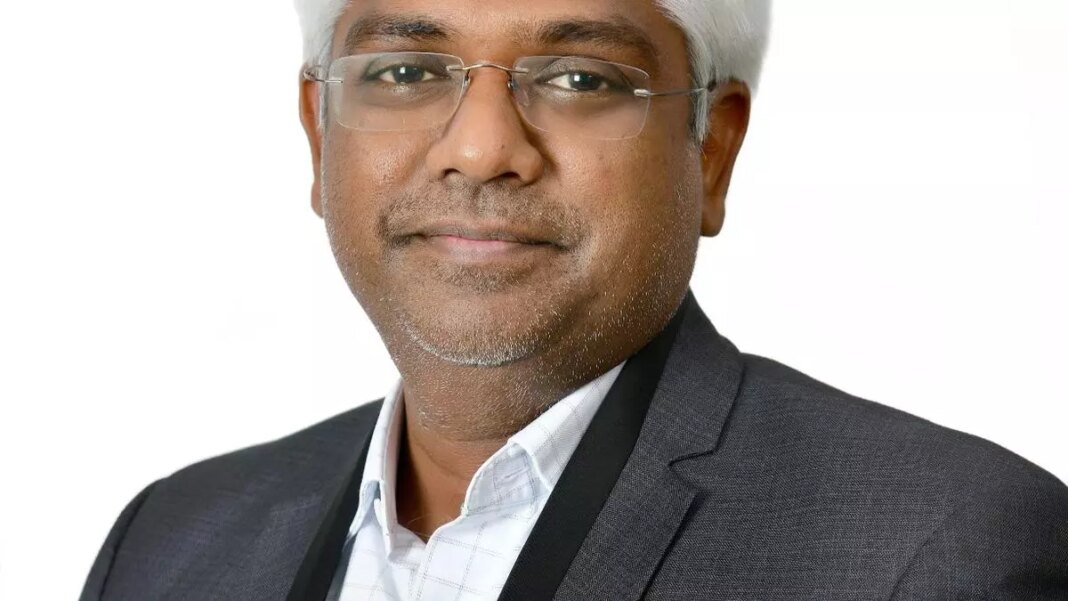 Professional man in suit smiling against white background.