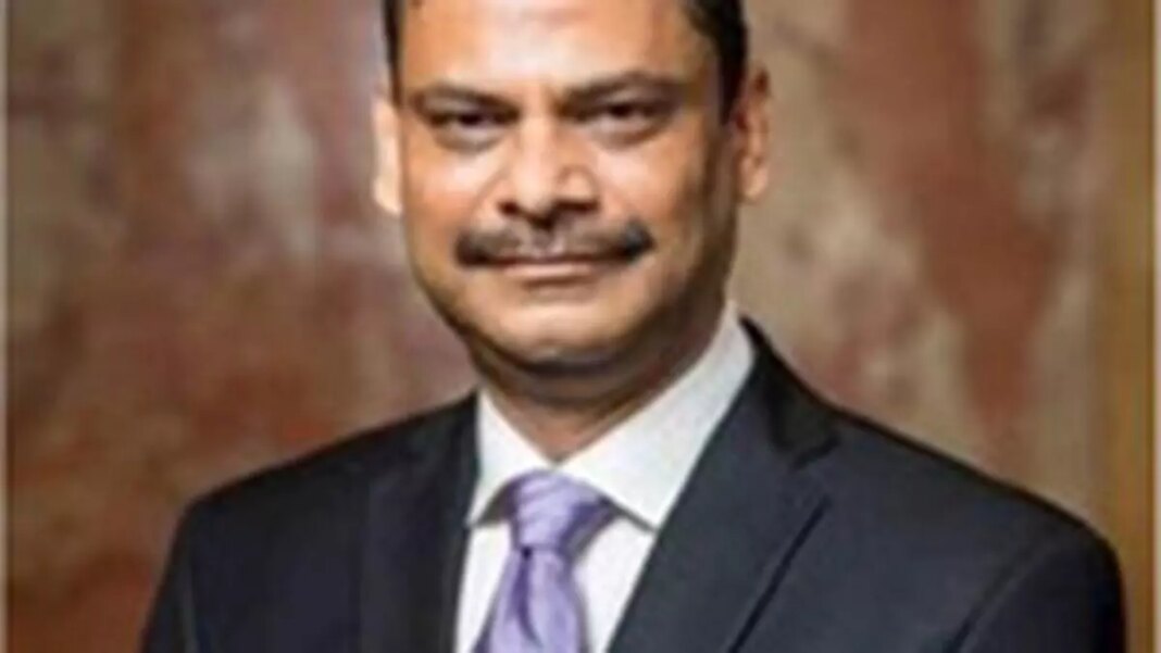 Man in suit with tie, professional portrait, blurred background.