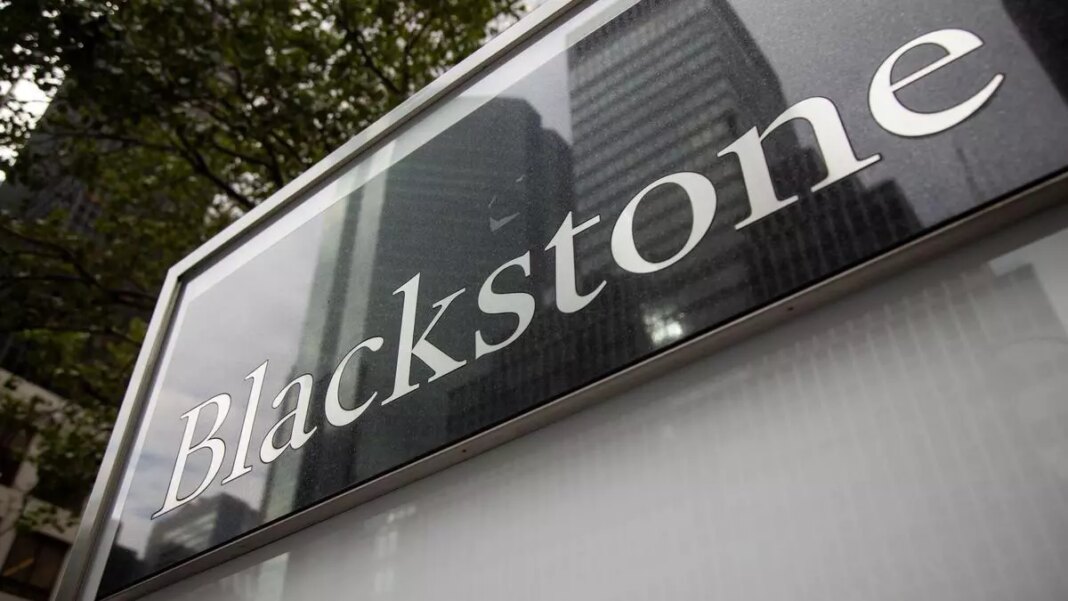 Blackstone company sign with reflective glass and trees.