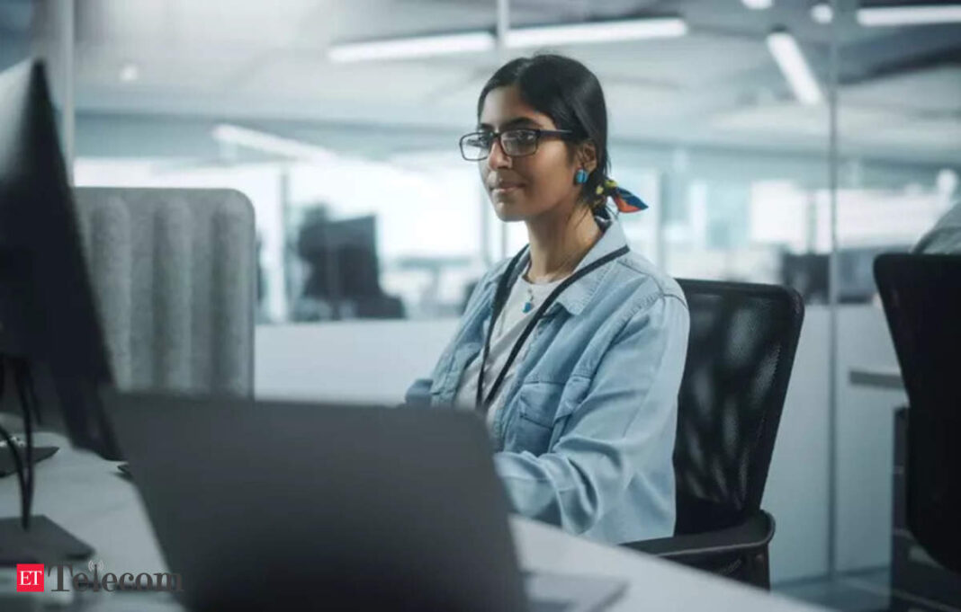 Woman working at office computer desk.