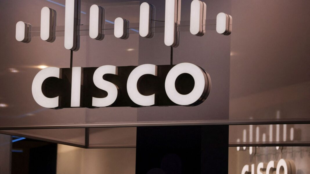 Cisco logo on illuminated sign indoors.