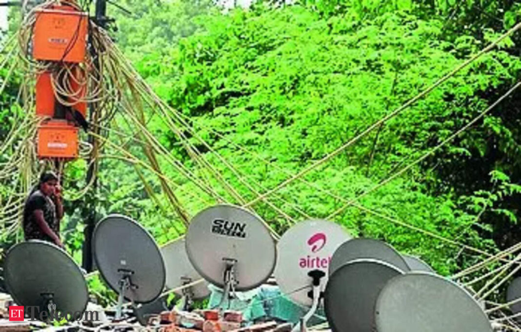 Technician with satellite dishes and tangled cables.