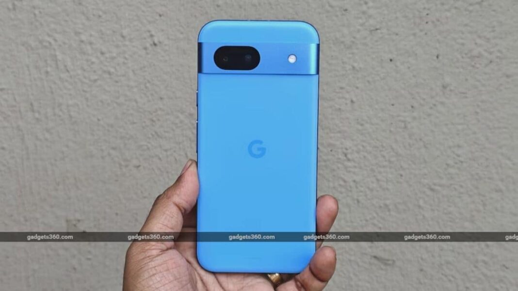 Hand holding blue smartphone with dual cameras.