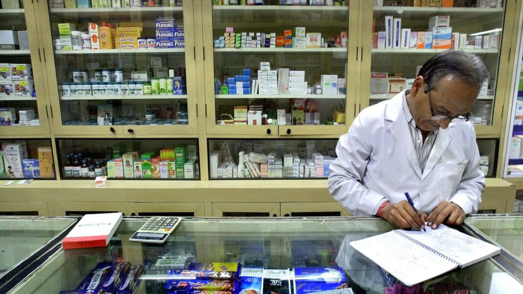 Pharmacist writing prescription in drugstore.