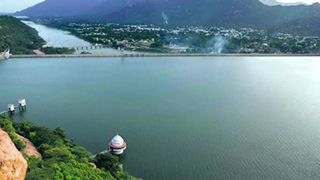 Aerial view of scenic lake with mountains and town.