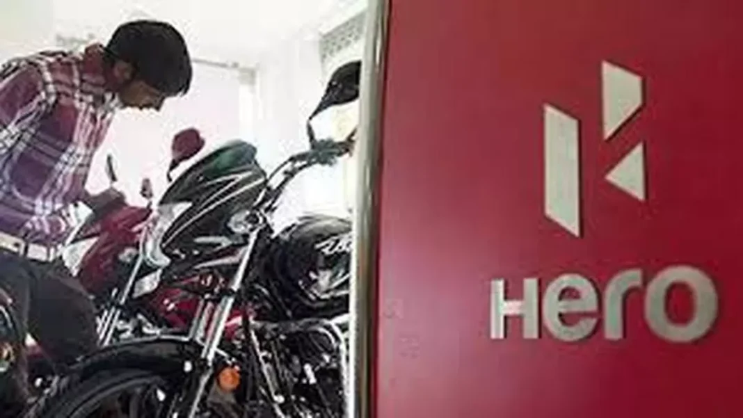 Man examining motorcycles at Hero dealership.