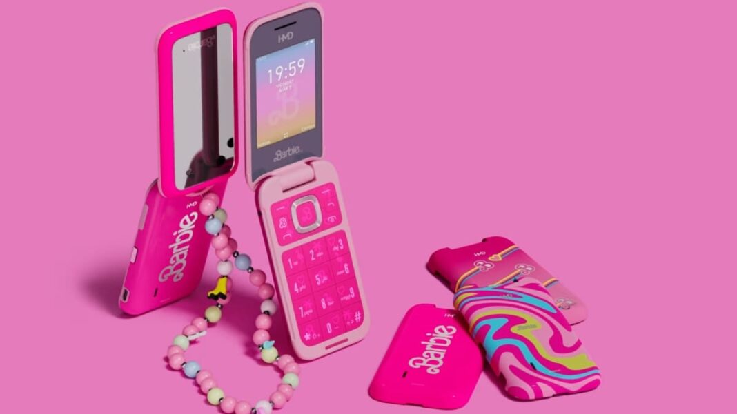 Barbie-themed pink flip phones with accessories on pink background.