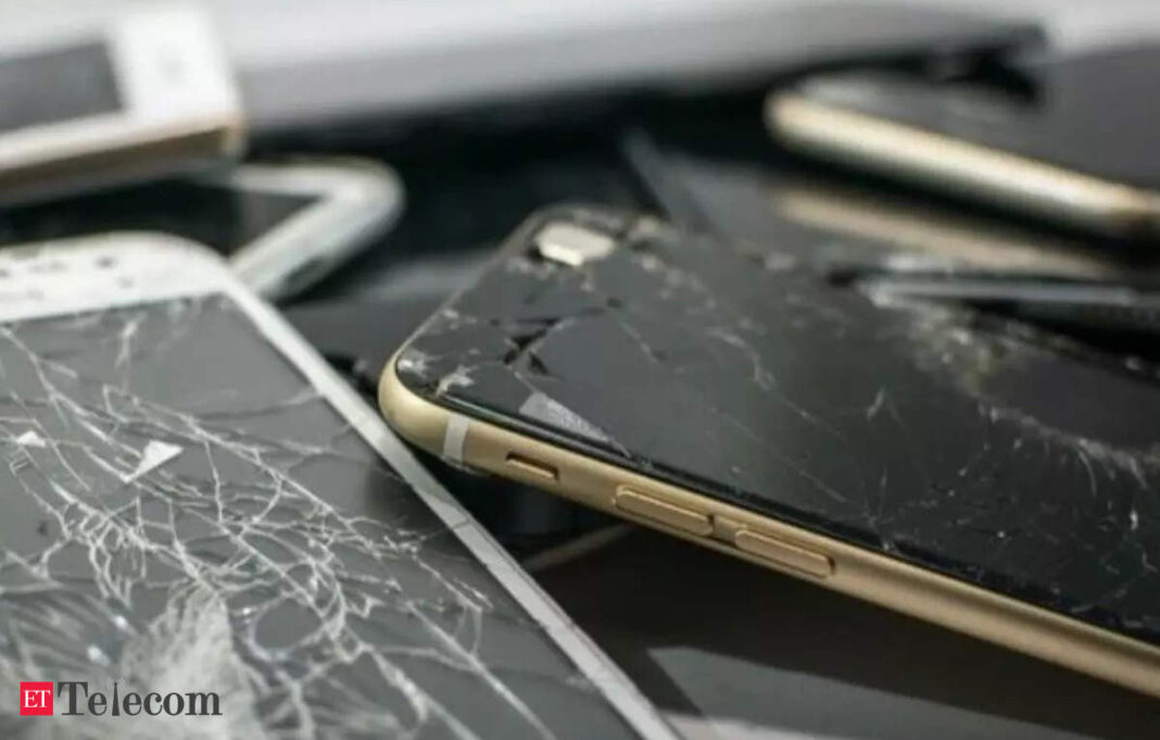 Damaged smartphones with cracked screens.