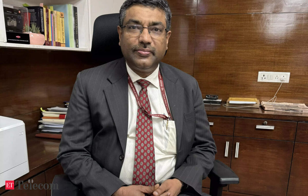 Man in suit sitting in office.