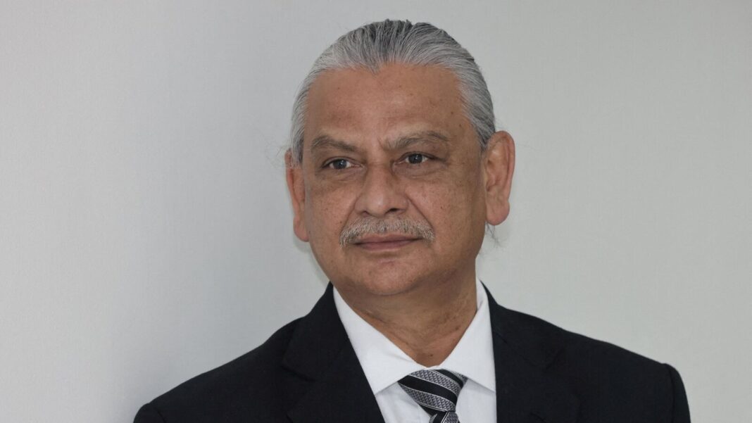 Senior man in suit with striped tie.