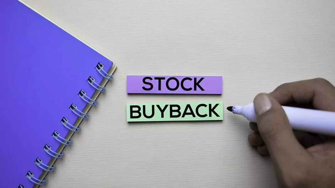 Person writing "STOCK BUYBACK" on sticky notes.