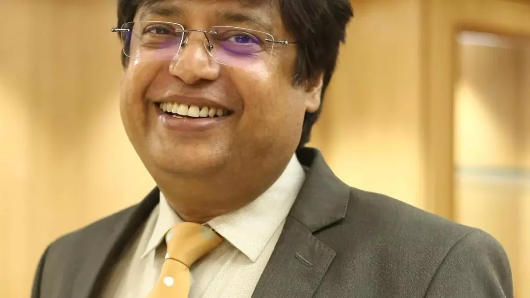 Smiling businessman in suit with glasses.