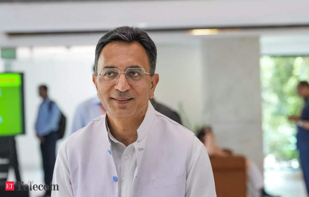 Smiling man in glasses at business event.