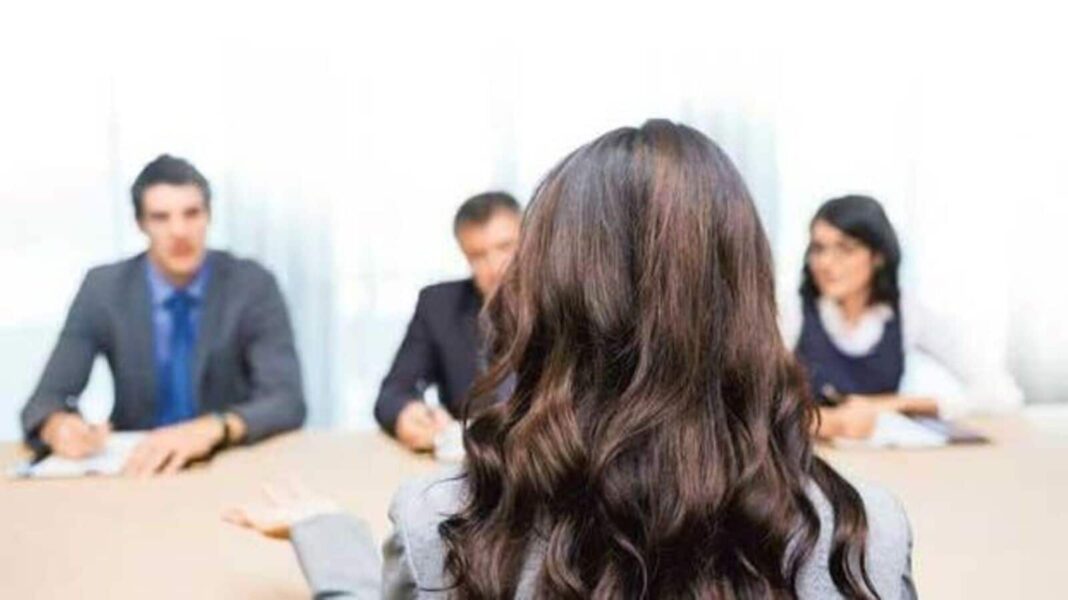 Woman interviewing for job with panel.