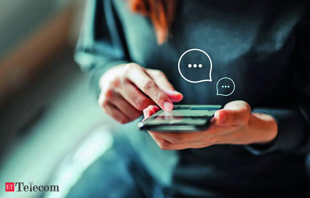 Person texting on smartphone with chat bubbles graphic.