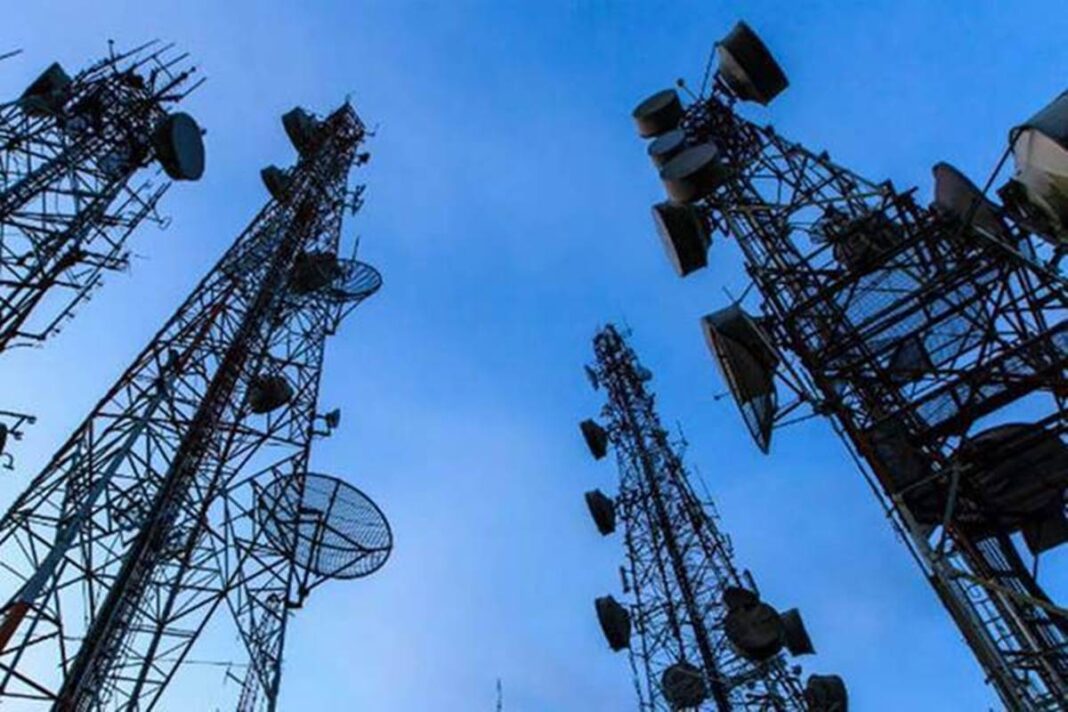 Cellular towers against clear blue sky.