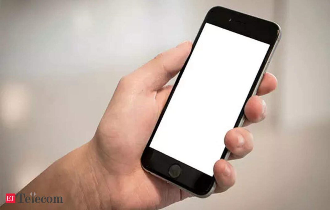 Hand holding smartphone with blank screen.