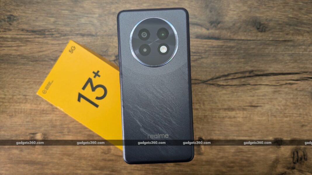 Realme smartphone and 5G card on wooden surface.