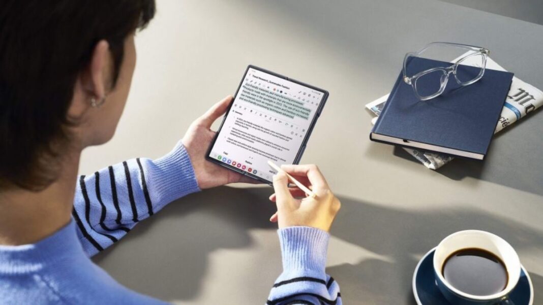 Person using tablet with stylus near coffee and eyeglasses.