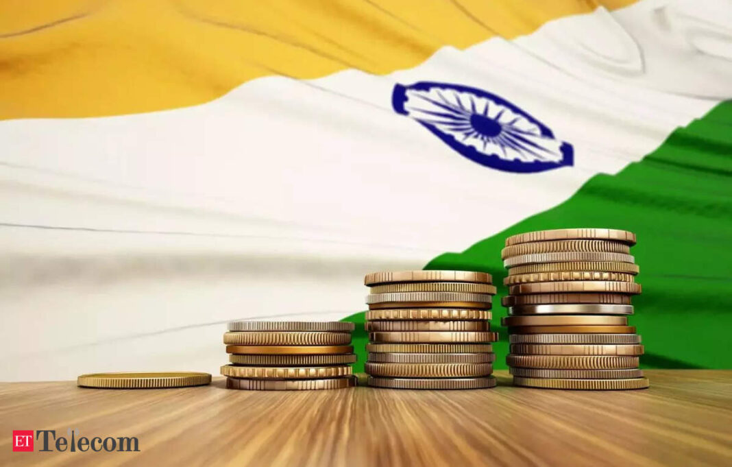 Indian flag and stacked coins on table.