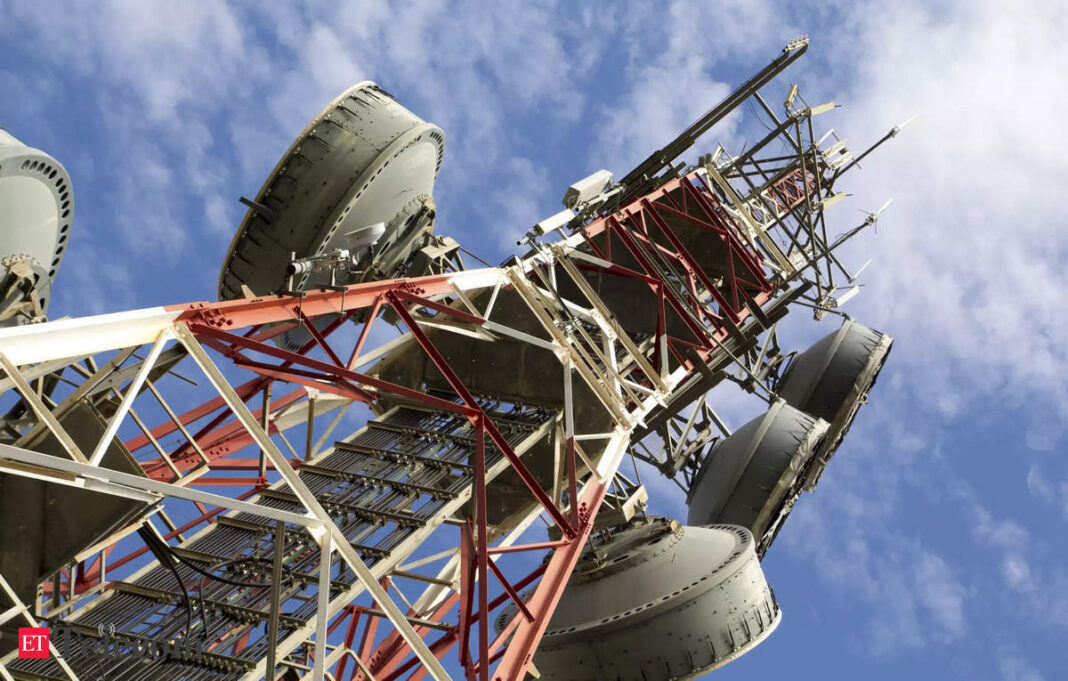 Telecommunication tower with antennas against blue sky