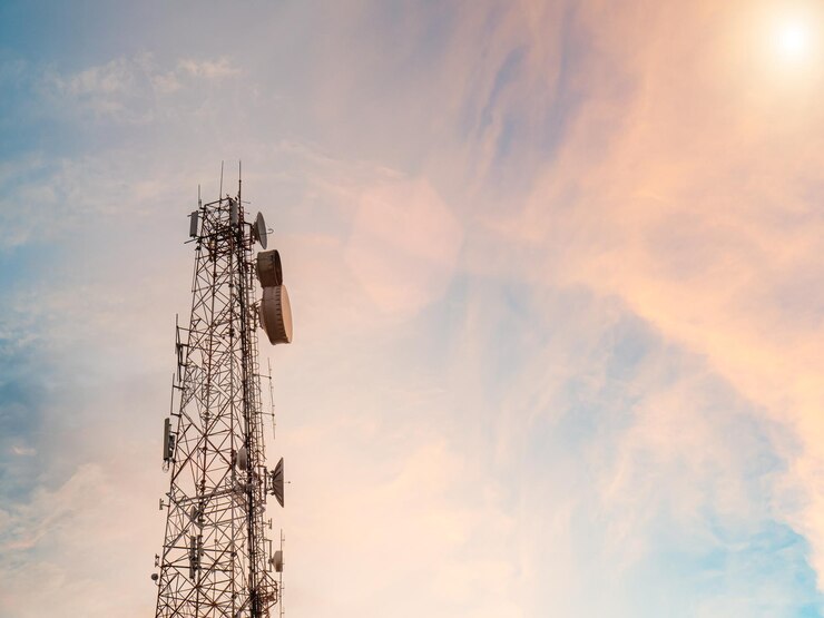 Telecommunication tower against sky at sunset