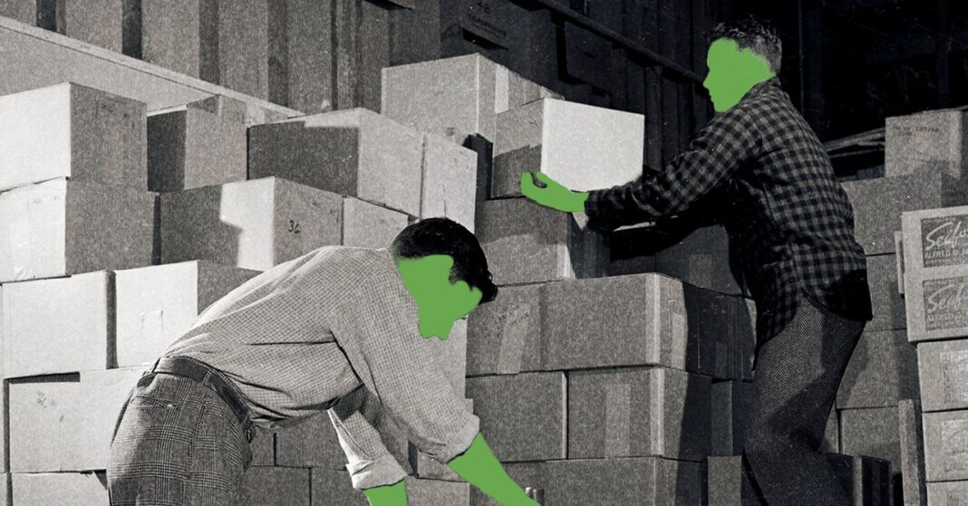 Workers stacking blocks in warehouse.