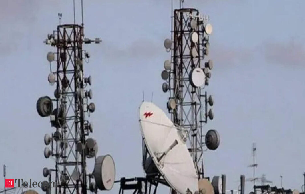 Telecommunication towers with antennas and dishes.