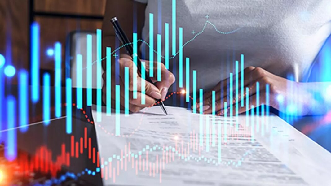 Person analyzing financial graphs with pen.